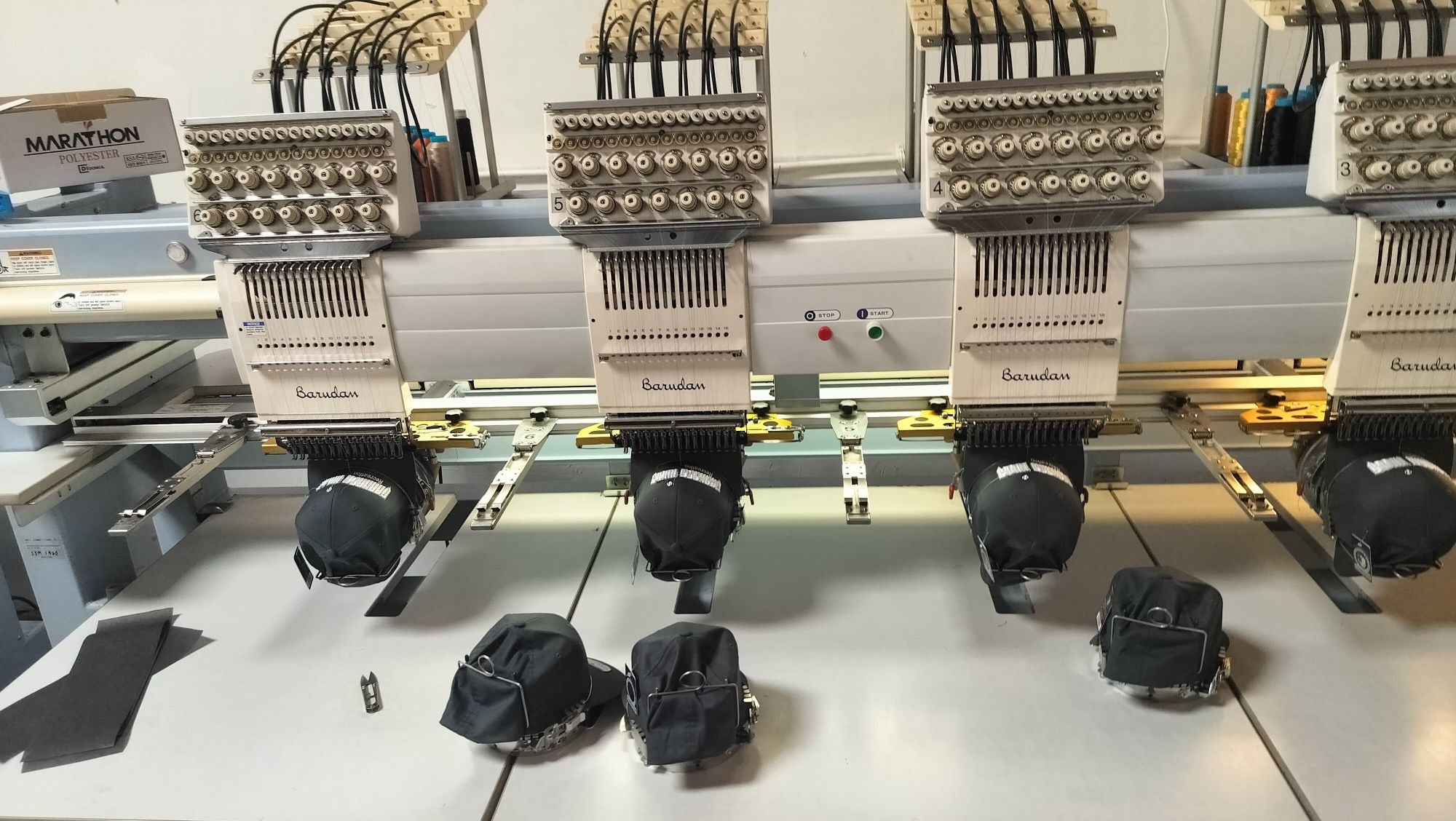Embroidery machine stitching hats at DARTMAR
