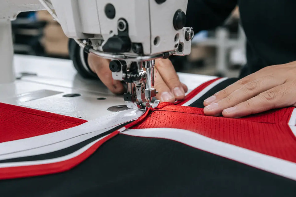 Industrial sewing machine stitching custom athletic jersey panels
