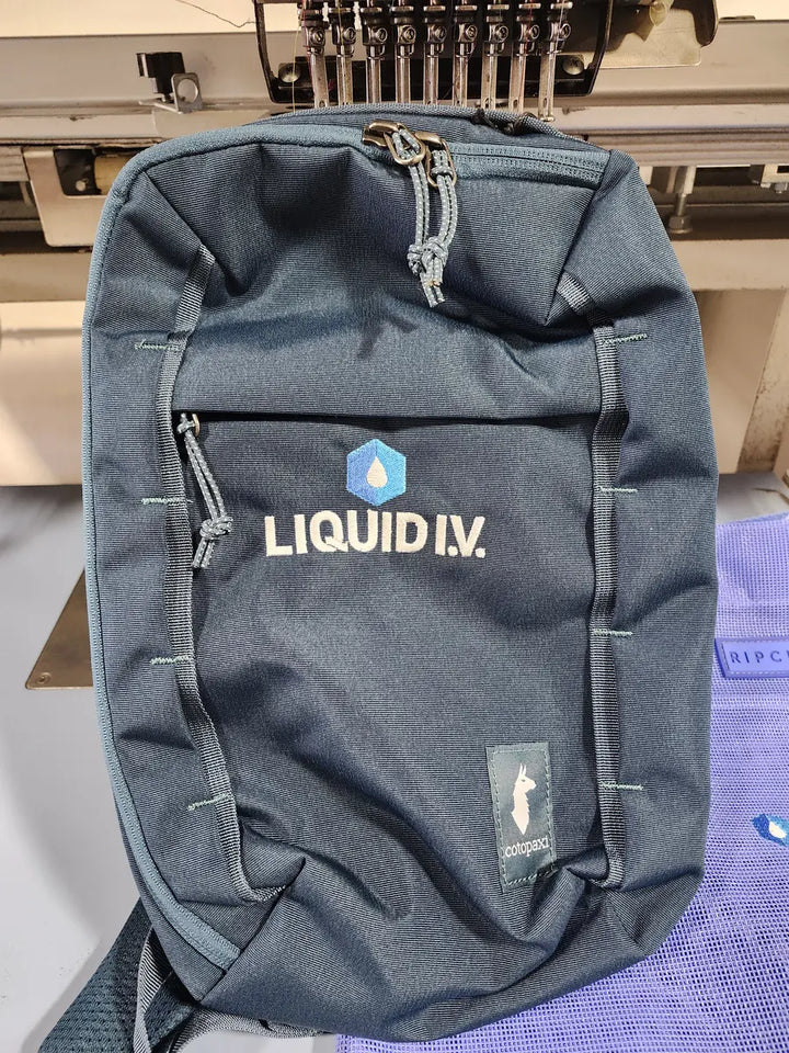 Liquid I.V. logo embroidered on a Cotopaxi bag by DARTMAR