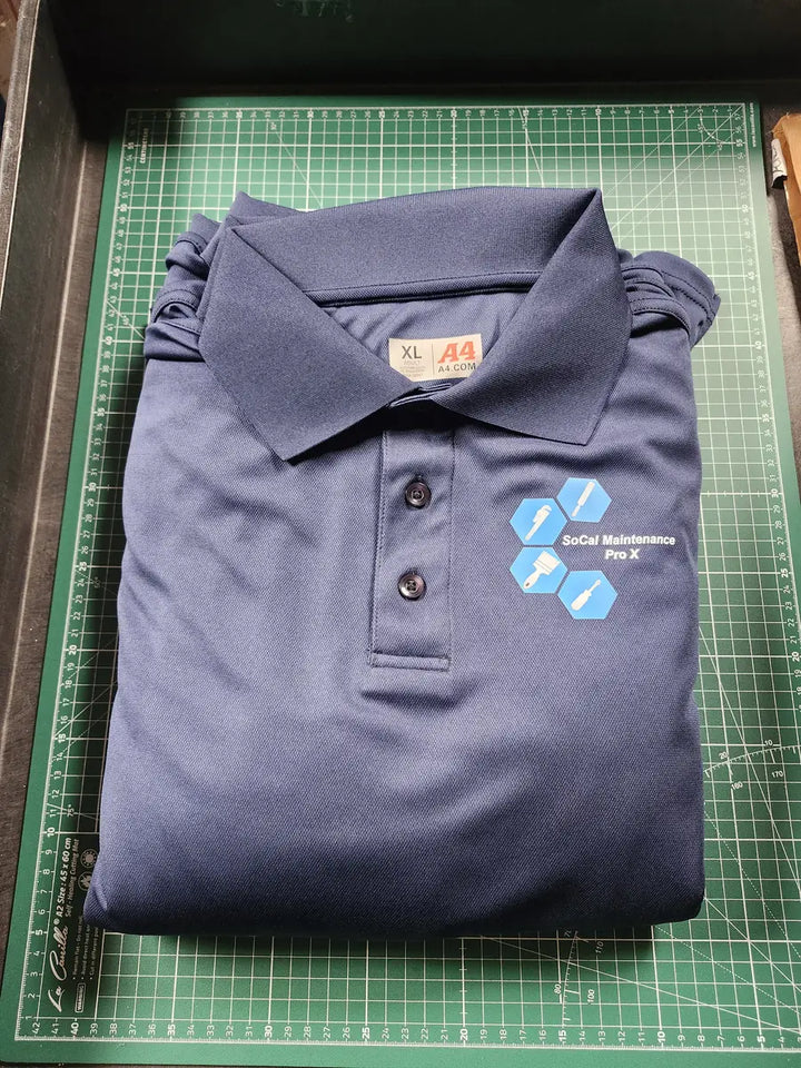 SoCal Maintenance Pro X logo on navy polo shirt produced by DARTMAR